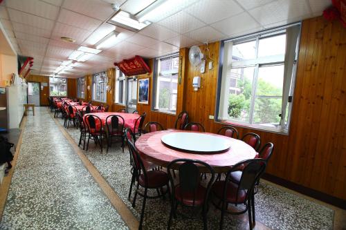 a dining car of a train with tables and chairs at Yeashow Villa in Fenqihu