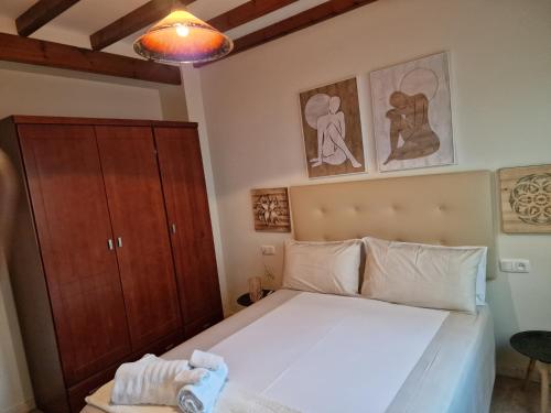 a small bedroom with a bed and a cabinet at Airam Home Patio Centro in Almansa
