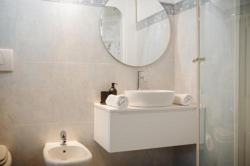 a white bathroom with a sink and a mirror at ELBI Suites - Countryside Retreat in Liedolo