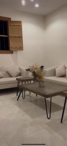a living room with a couch and a coffee table at منتجع شرفا السياحي البيئي in Hail