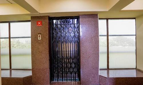 a glass door in a building with windows at FabExpress Jayshree - Nr Mumbai International Airport in Mumbai