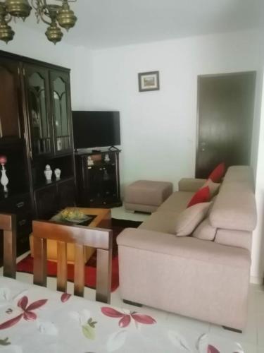 a living room with a couch and a table at apartamentos lazarino1 in Nazaré