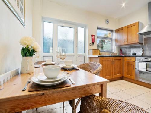 a kitchen and dining room with a wooden table and chairs at Pass the Keys 55 Heworth Village Wonderfully Cosy Family Home in York in York