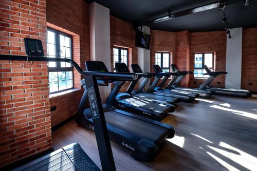 a row of treadmills in a gym with a brick wall at Luxury 1 Bed in Longbeach in Iskele