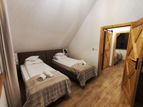 2 łóżka w małym pokoju z lustrem w obiekcie Przystanek Gorce w Nowym Targu