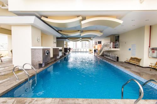 a swimming pool in the lobby of a hotel at JMM Grand Suites in Manila