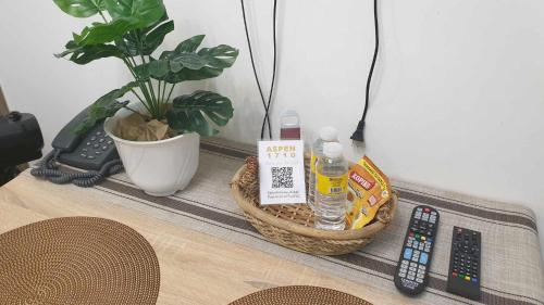 a table with a basket and remote controls on it at Fame Residences Tower 2 in Manila
