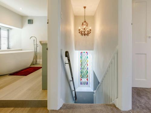 a bathroom with a staircase and a chandelier at 2 Bed in Launceston 84660 in Tresmeer