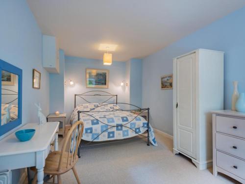 a bedroom with a bed and a desk and a table at 1 Bed in Matterdale SZ222 in Watermillock