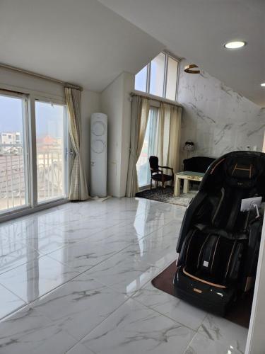 a room with a black suitcase sitting on the floor at HANI Haus in Jeju