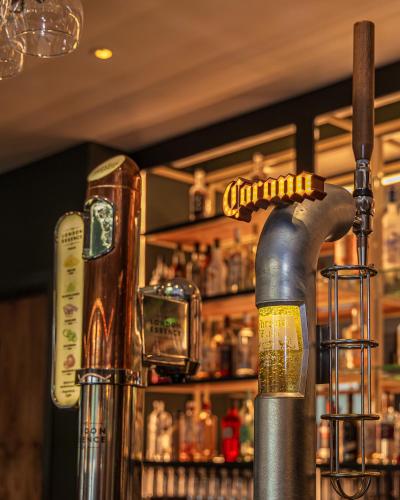 a bar with a drink dispenser on the counter at Crowne Plaza Newcastle - Stephenson Quarter by IHG in Newcastle upon Tyne