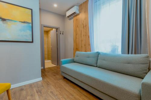 a living room with a couch and a window at Nobel Gallery Hotel in Belgrade