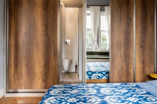 a bedroom with a bed and a door to a bathroom at Historical Apt. with Galata Sea View/Turkish Hamam in Istanbul
