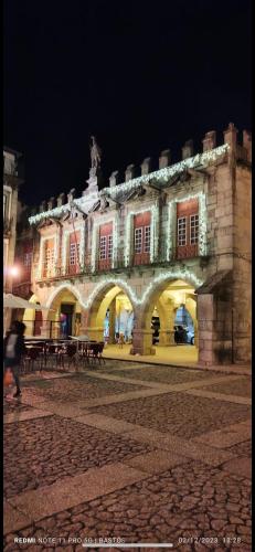 a large building with tables in front of it at night at FERREIRA'S HOUSE Guimarães in Guimarães