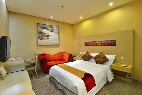 a hotel room with a bed and a red chair at Shenzhen Sunon Hotel,Dongmen (Formerly Sunon Holiday Villa Hotel) in Shenzhen