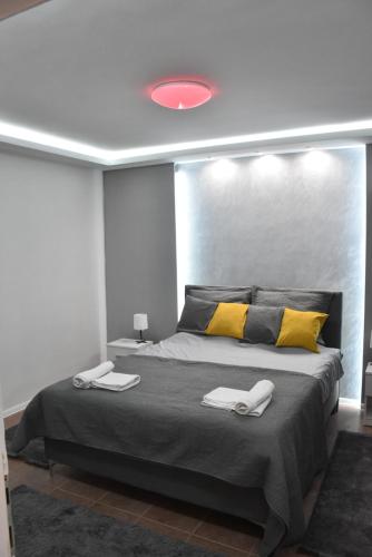 a bedroom with a large bed with two towels on it at BeLux apartment in Niš