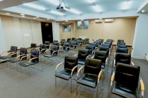 a conference room with chairs and a whiteboard in it at Nobel Gallery Hotel in Belgrade