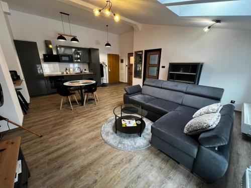 a living room with a couch and a table at MYE Apartments - Kamienica Sienkiewicza in Łódź