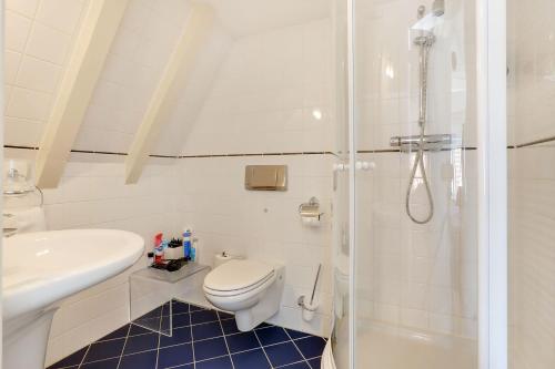 a bathroom with a toilet and a sink and a shower at City-centre, Canal-house, luxurious , stylish bedroom, ensuite bathroom in Amsterdam