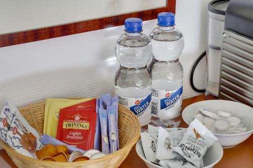 two bottles of water sitting on top of a table at City-centre, Canal-house, luxurious , stylish bedroom, ensuite bathroom in Amsterdam