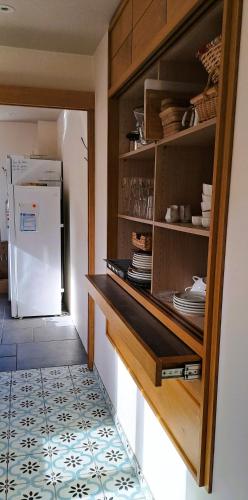 a kitchen with a counter and a refrigerator at Un air de bourlingueurs in Pepinster