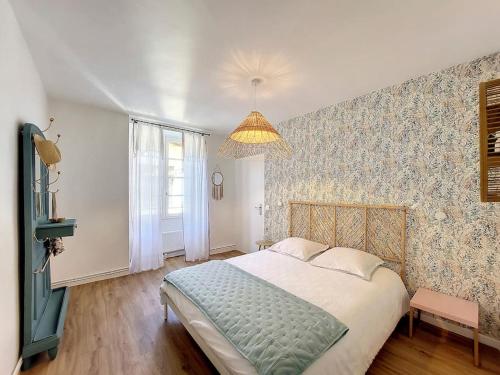 a bedroom with a large bed and a large window at Le TouCan - 100m Palais et Pont in Avignon