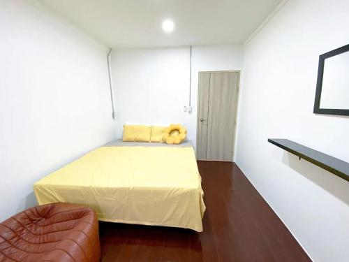 a bedroom with a bed with a teddy bear on it at 3BR entire house next to Skytrain(BTS) and Subway(MRT) Chatuchak in Bang O