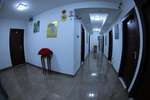 a hallway with white walls and a tile floor at Trinity Hotel in Addis Ababa