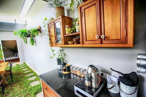 a kitchen with a counter with a stove and a cabinet at Beautiful Modern Garden Home in Kampot