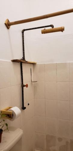 a bathroom with a toilet paper dispenser on the wall at Tus Recuerdos in Santo Domingo