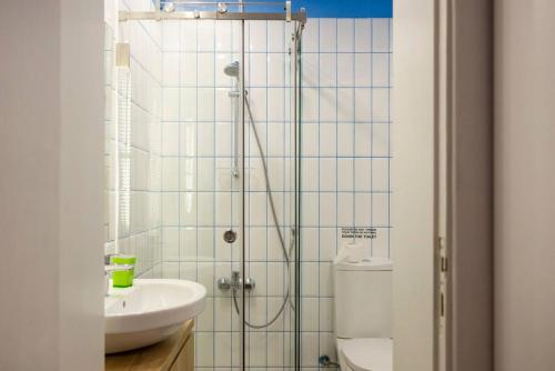 a bathroom with a shower and a toilet and a sink at Hidden Gem 1BR Apartment in Beirut