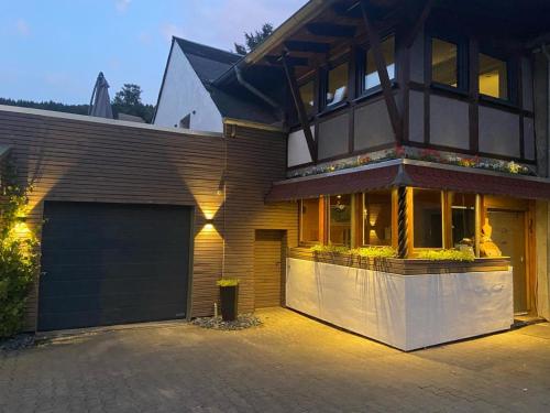 a house with a garage in front of it at Dhrontalstube in Gräfendhron