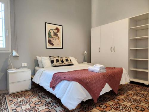 a bedroom with a large bed with a red blanket at Little Urban Palace 4BR Beirut in Beirut