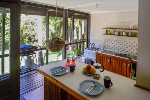 a kitchen with a counter with plates on it at Noah Creek Eco Huts in Cape Tribulation