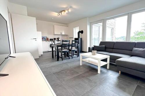 a living room with a couch and a table at Apartmenthaus Scharmützelsee inkl Nebenkosten in Wendisch Rietz
