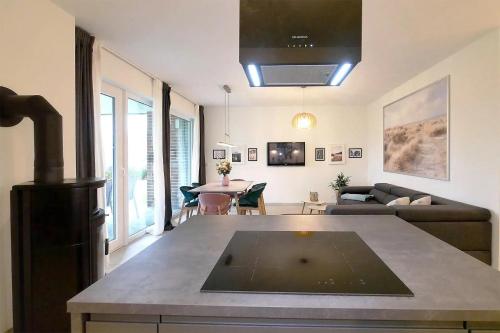 a living room with a couch and a table at Apartmenthaus Scharmützelsee inkl Nebenkosten in Wendisch Rietz