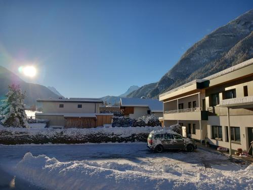 a car parked in a parking lot in front of a building at MyHome Apartments Umhausen in Umhausen