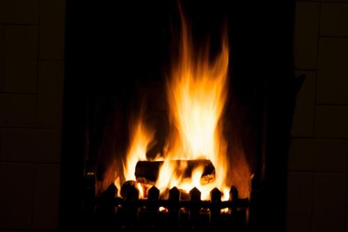 a fire in a fireplace with flames at The Jolly Sportsman in Lewes