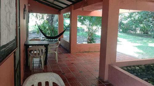 a porch of a house with a table and chairs at Hospedaje Eden in Los Naranjos