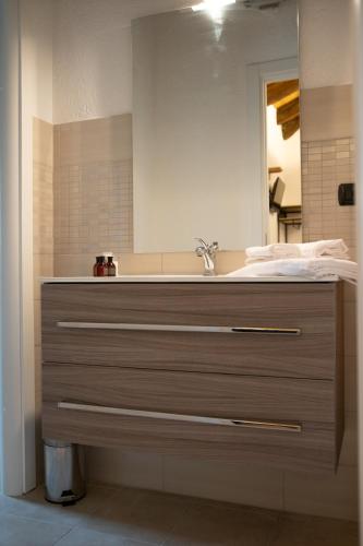a bathroom with a sink and a mirror at Green Mountain Lodge in Sauze dʼOulx