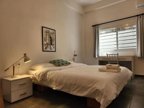 a bedroom with a large bed and a window at Railway House 2BR Apt w front yard in Beirut