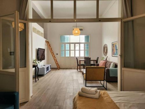 a room with a bed and a living room at Spacious 2 Bedroom Apt In Mar Mikhael in Beirut