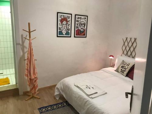 a bedroom with a bed and a cross on the wall at Skylight 1BR Apartment Mar Mikhael in Beirut
