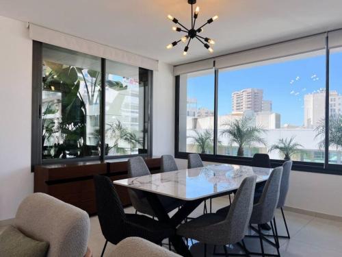 a dining room with a table and chairs at Elevated 2BR living in Hamra in Beirut