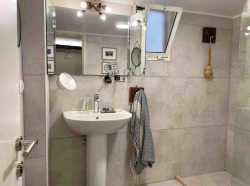 a bathroom with a sink and a shower at Designer 1BR apt in Gemmayze in Beirut