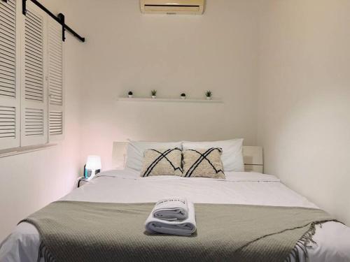 a bedroom with a bed with a scale on it at Artist Nest In Getaoui, Achrafieh in Beirut