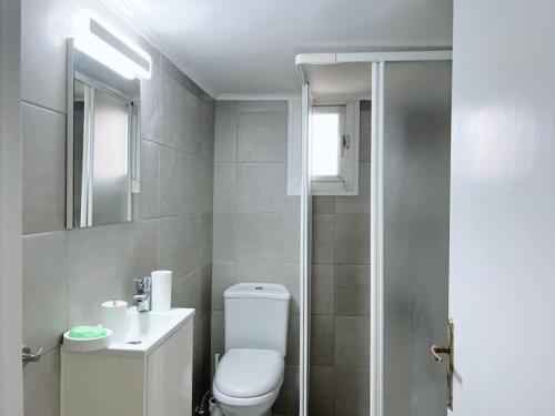a bathroom with a toilet and a sink and a shower at Artist Nest In Getaoui, Achrafieh in Beirut