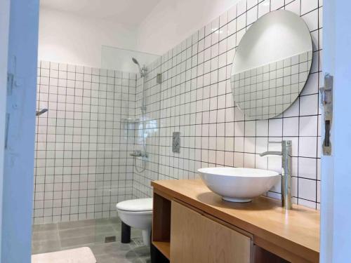 a bathroom with a sink and a toilet and a mirror at Bright Loft 4BR MarMikhael in Beirut