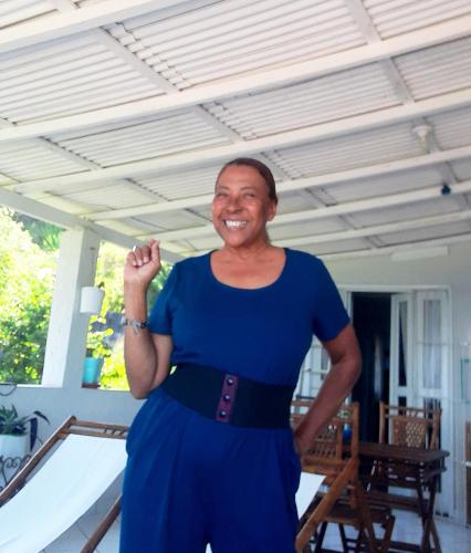 a woman in a blue dress posing for a picture at Casa na praia de Setiba com panorama fantástico in Guarapari