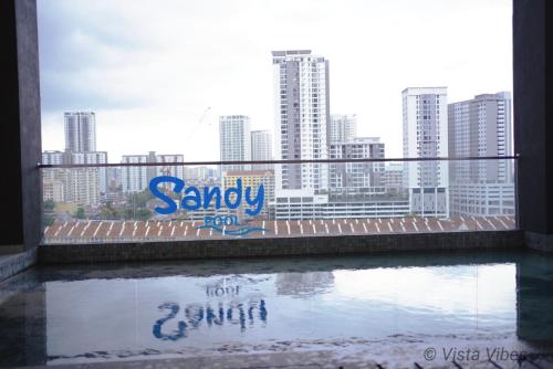 a view of a city skyline from a window at Urban Suites Homestay by Vista Vibes in Jelutong